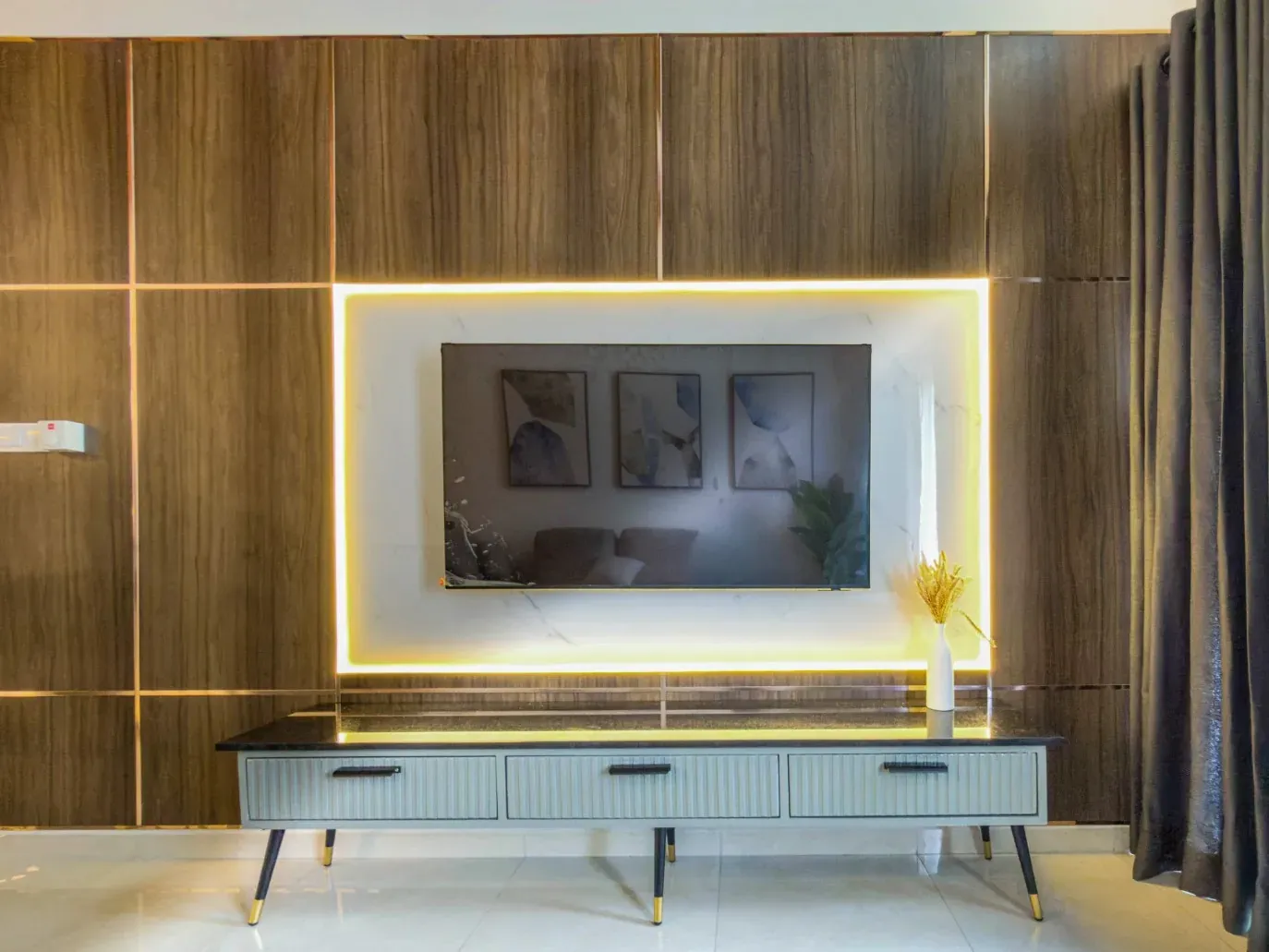 Timber-panelled TV wall with a backlit frame and fluted media unit