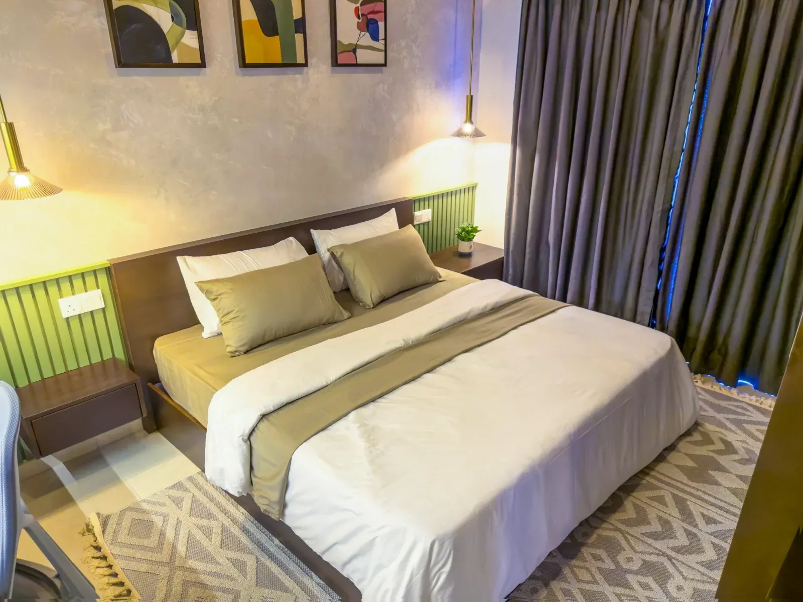 Bedroom with a walnut headboard set against green slatted wall panelling