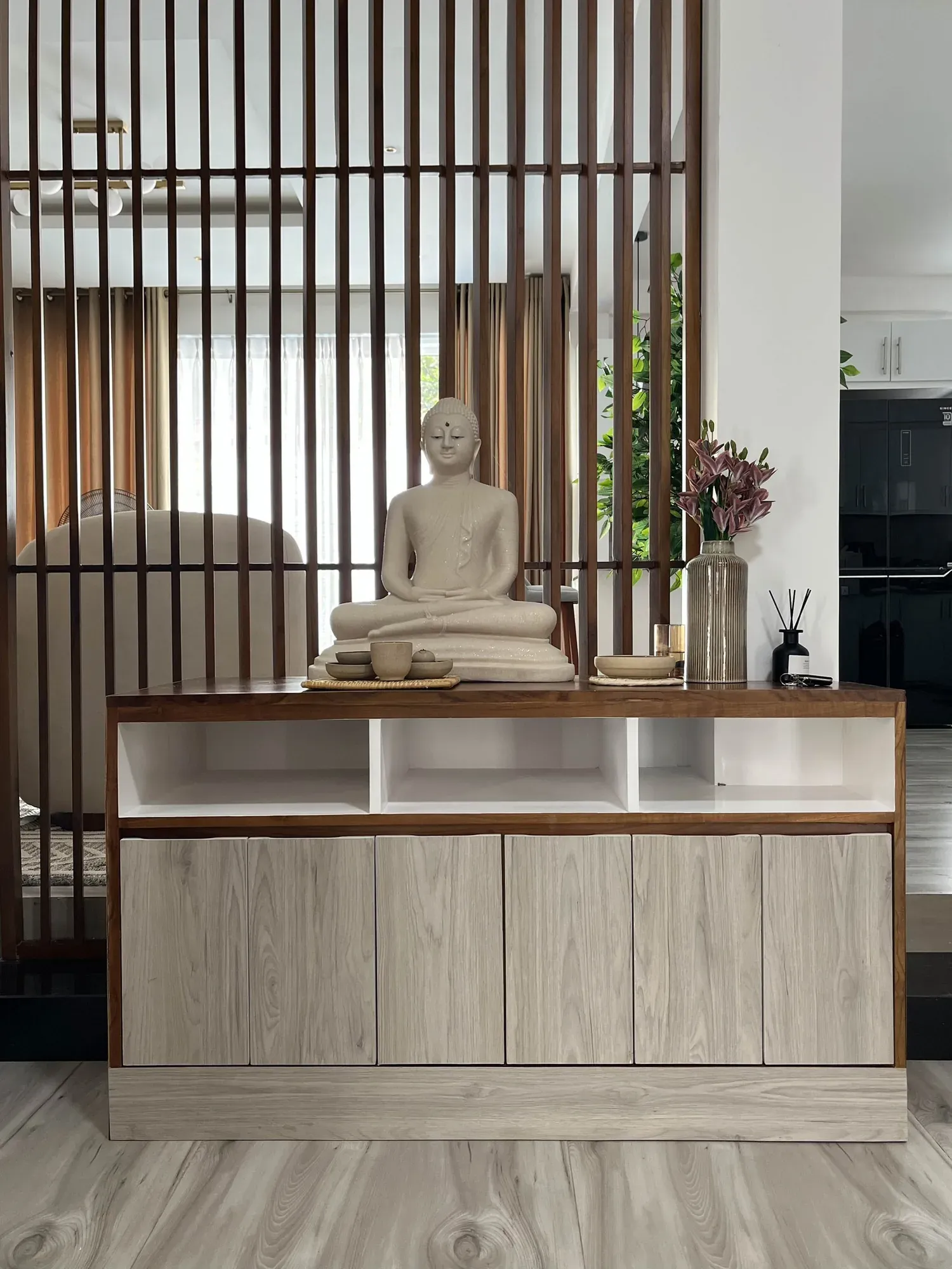 Sideboard in front of a slatted timber room divider