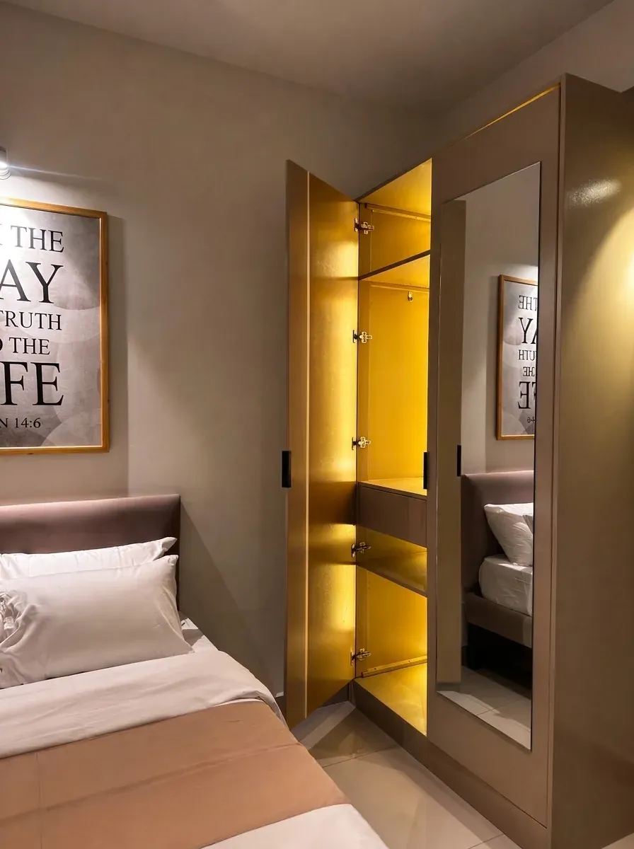 Second bedroom wardrobe with gold-lined, lit interior