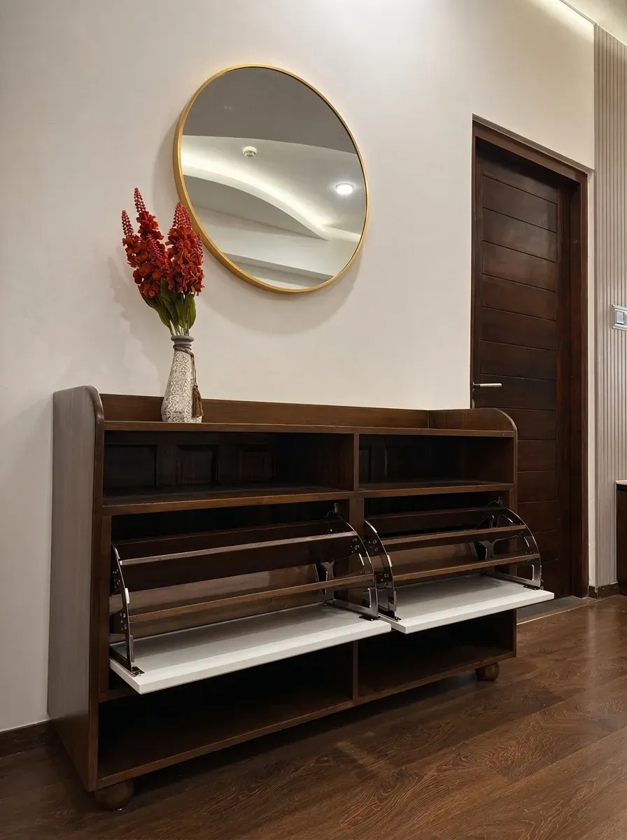 Walnut shoe cabinet with flip-down trays beneath a round mirror